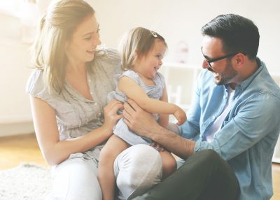 mother and father holding their daughter